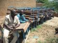 les tables-bancs terminées, avec Bob Niangaly et Bouba, l'entrepreneur
